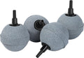 Four 2-inch aquarium air stones producing ultra-fine bubbles inside a freshwater fish tank to improve oxygen levels for tropical fish and aquatic plants.